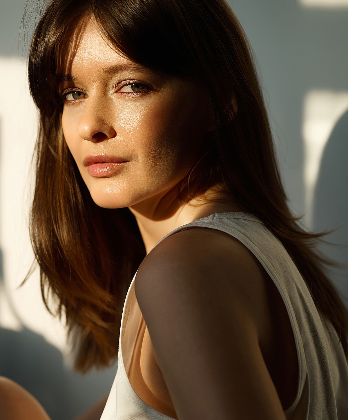 Woman with long hair in sunlight portrait.