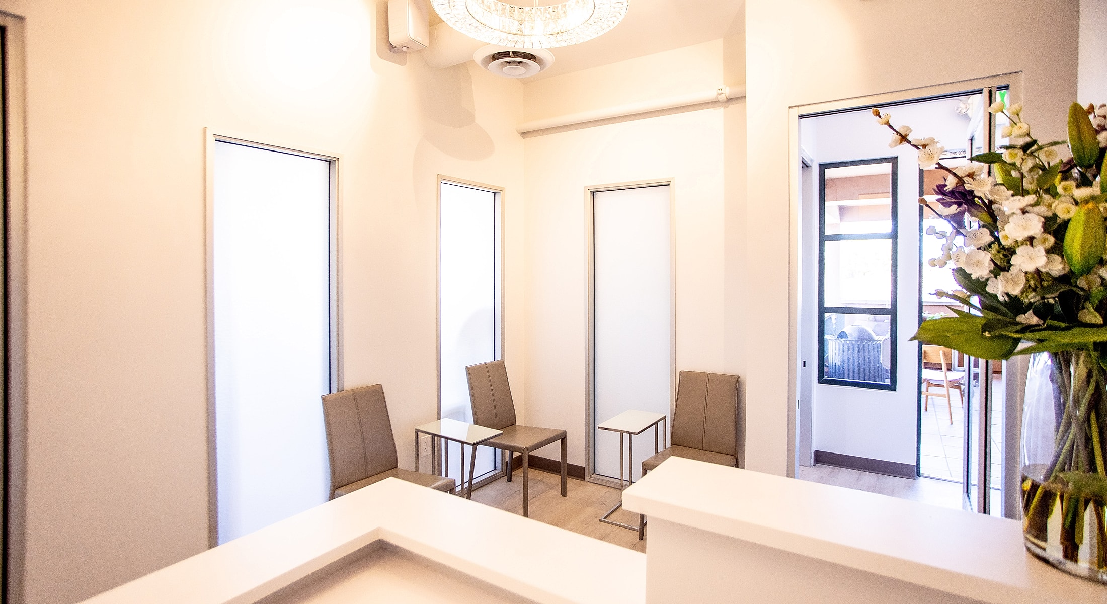 Modern waiting area with seating and flowers.