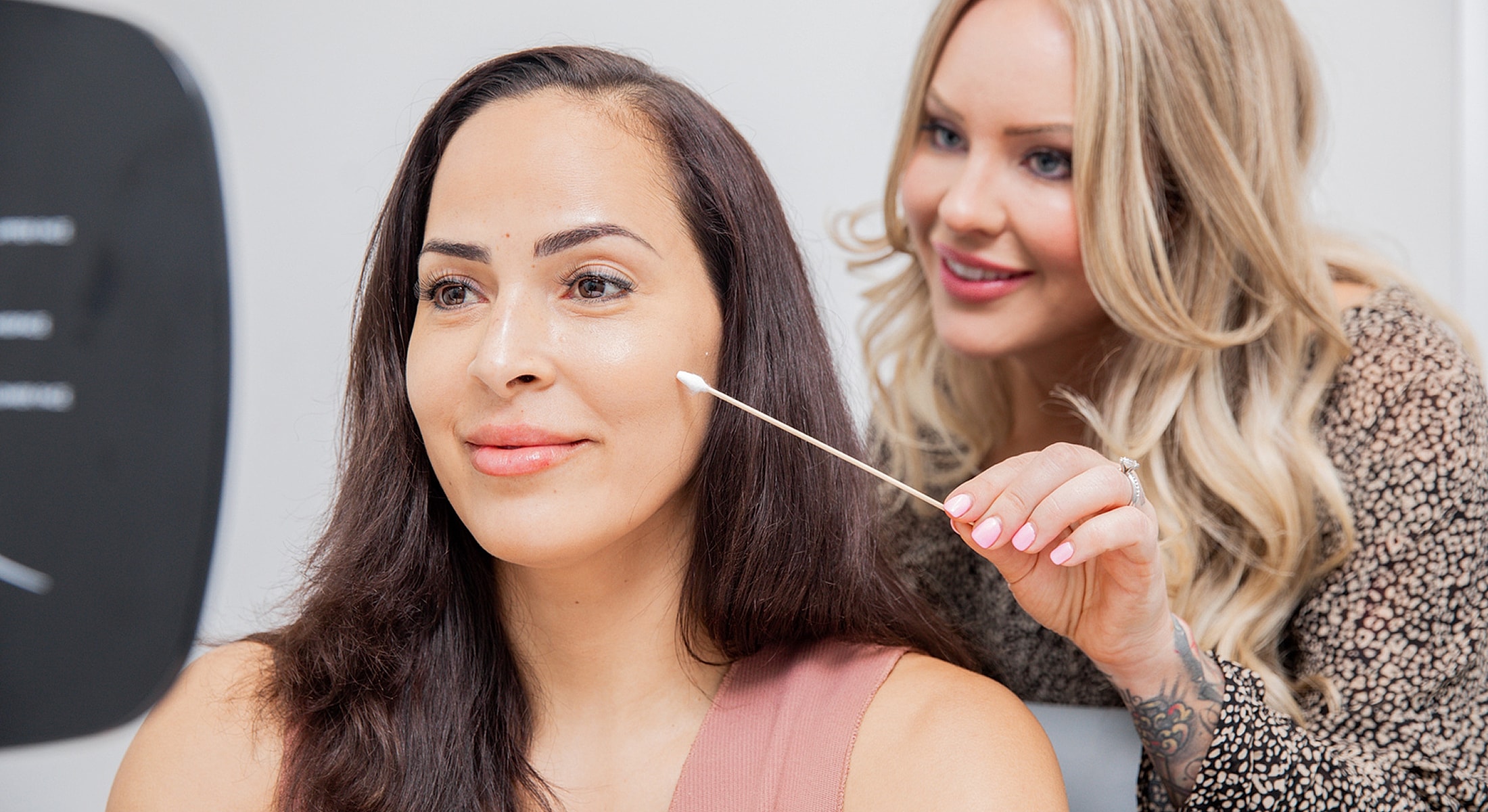 Applying skincare product in beauty consultation session.