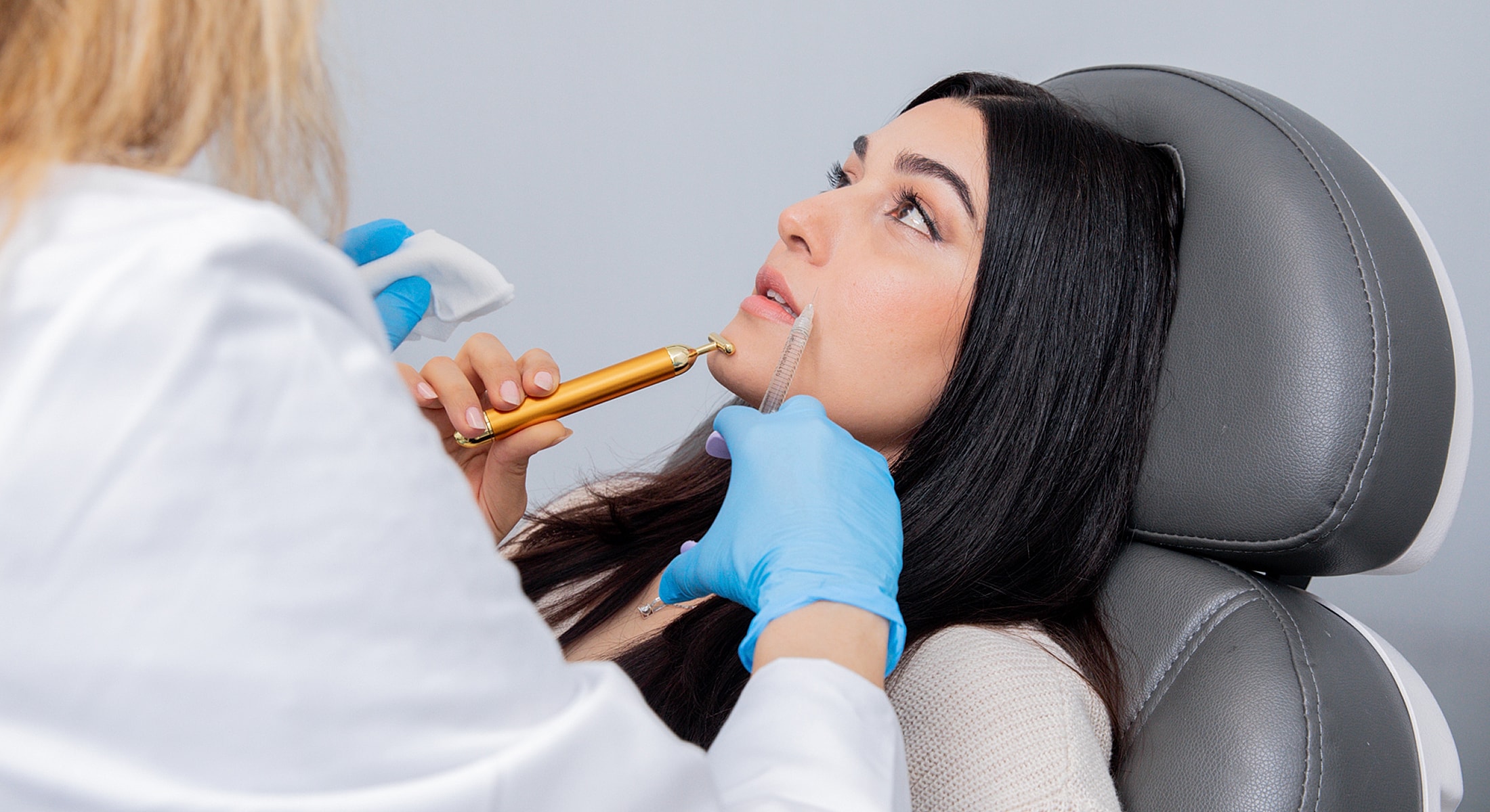 Patient receiving facial treatment in clinic setting.