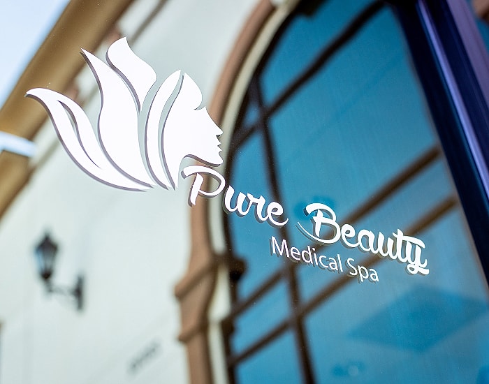 Logo of Pure Beauty Medical Spa on window