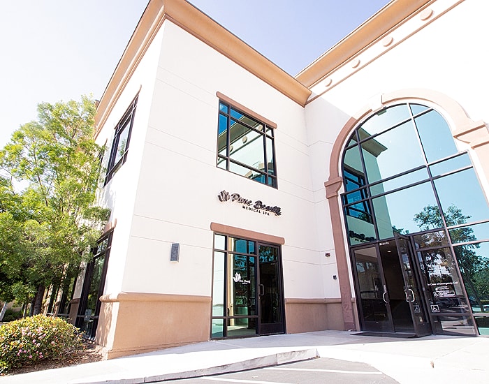 Modern building exterior with glass entrance.